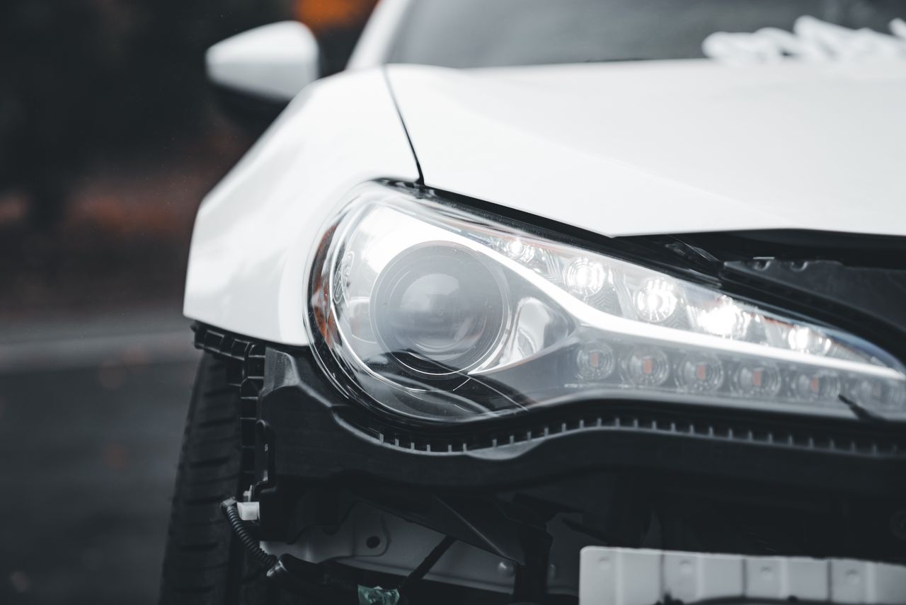 Detailed view of a modern car headlight with stylish design and sleek lines.